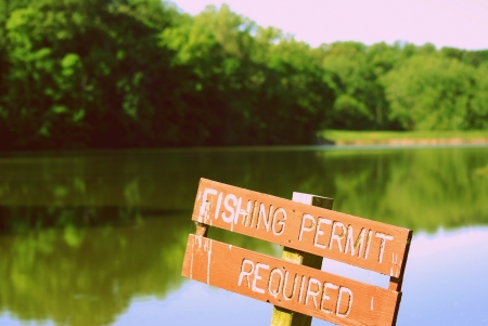 Fishing Permit Required Sign on a lake の写真素材