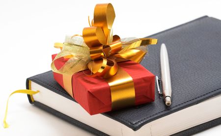 red gift and notebook with penの写真素材