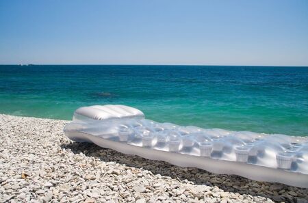 inflatable mattress on on the beach seaの写真素材