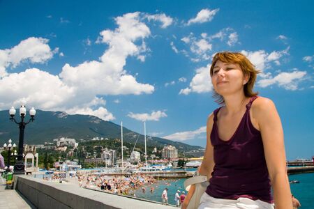 happiest woman in the sea resort against a backdrop of blue skyの写真素材