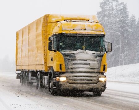 a moving truck during a heavy snowの写真素材