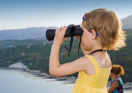 A child looking through binocularsの写真素材