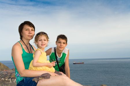 mother with children on the beachの写真素材