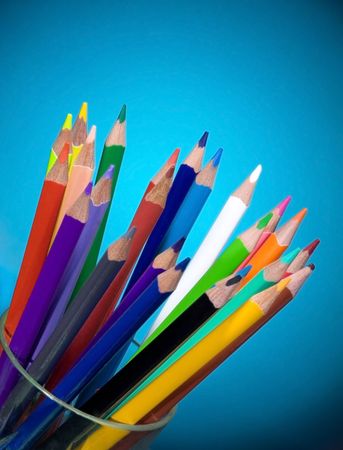 Colour pencils on blue backgroundの写真素材