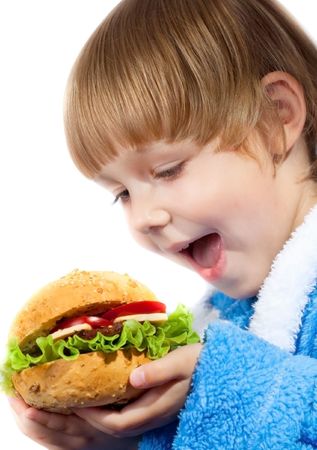 Young girl eating colorful appetizing hamburgerの写真素材