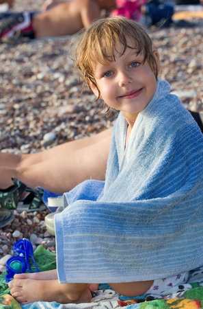 Little girl with towel on the beachの写真素材