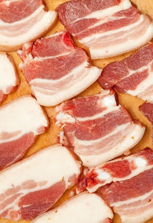 Tasty sliced ââpork bacon on a wooden boardの写真素材