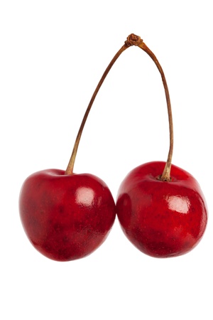 Two heart shaped cherry berries isolated on white background cutoutの写真素材