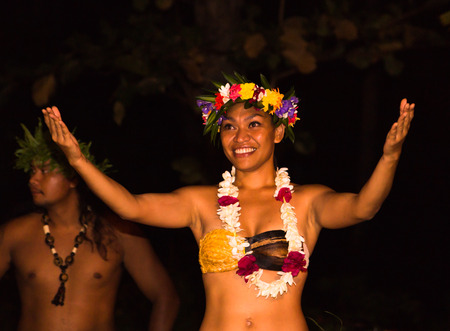 TAHAA, FRENCH POLYNESIA - CIRCA 2014: Polynesian men and women perform traditional dance circa 2014 in Tahaa.Polynesian dances are major tourist attraction of luxury resorts of French Polynesia.のeditorial素材