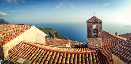 Bell tower in French Riviera town Eze  with sea on the backgroundの写真素材