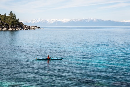 Man fishing from kayak at Lake Tahoeの写真素材