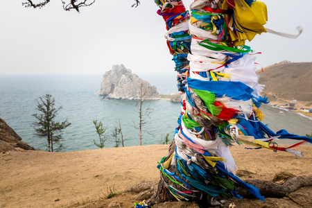 Colorful ribbons on the tree at Lake Baikal in Siberiaの写真素材