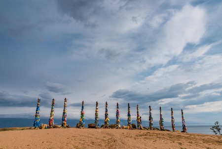Colorful ribbons on wooden poles at Lake Baikal in Siberia