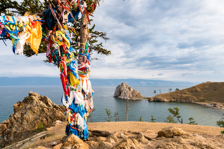 Colorful ribbons on the tree at Lake Baikal in Siberiaの写真素材