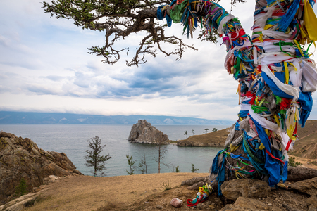 Colorful ribbons on the tree at Lake Baikal in Siberiaの写真素材