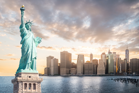 The Statue of Liberty with Lower Manhattan background in the evening at sunset, Landmarks of New York City, USAの写真素材