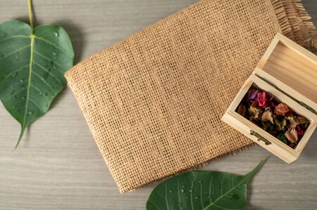 Top view minimal blurred background for present product on the table with leaves and matの写真素材