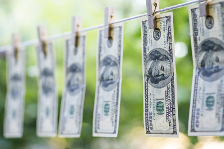 Money Laundering. Money Laundering US dollars hung out to dry. 100 dollar bills hanging on clotheslinesの写真素材