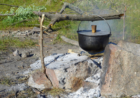 Cooking food in a bowler hat in the open airの写真素材