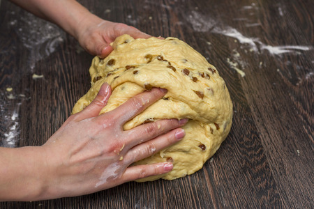 Female hands kneading and making bread doughの写真素材