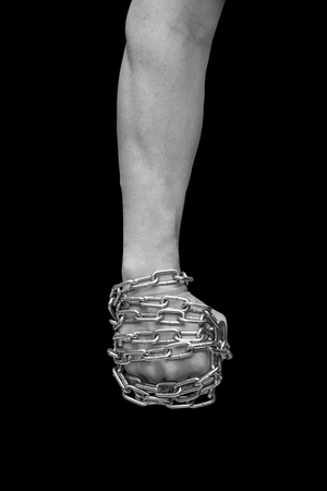 Fist of man in chains. Black and whiteの写真素材