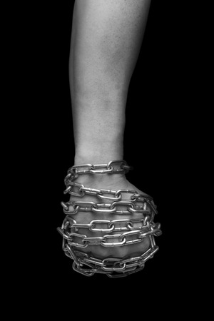 Fist of man in chains. Black and white