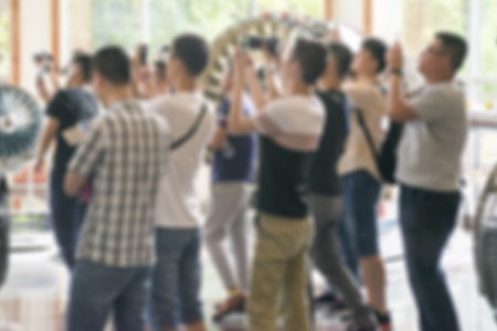 Group of people inside an exhibition hall, blurry