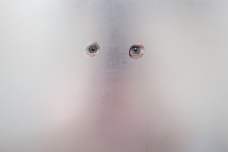 Reflection of the eyes in the sweaty mirror in the bathroomの写真素材