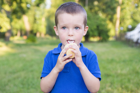 A child eats ice cream outdoorsの写真素材