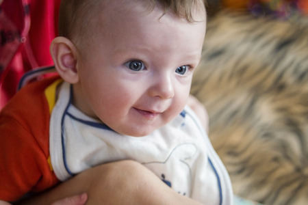 little kid in bib is smiling