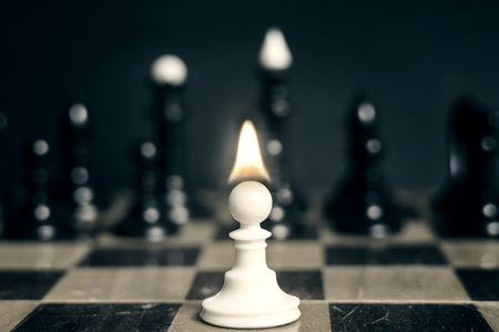 Single pawn with flame tongue on head against many enemiesの写真素材