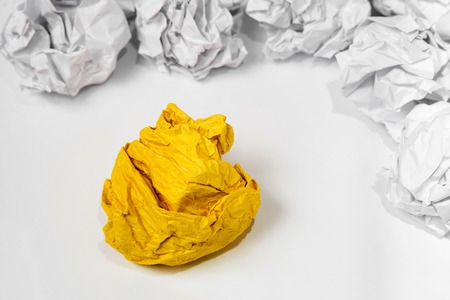 Set of crumpled paper balls with one yellow