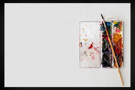 watercolor paints, brushes and blank white paper sheet. top viewの写真素材