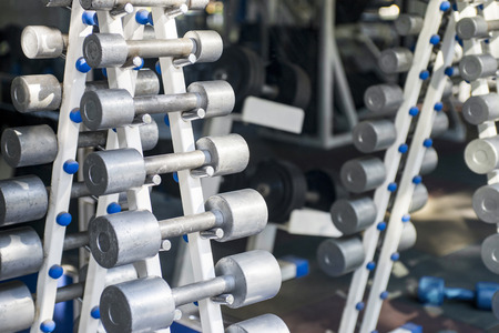 Rows of dumbbells in the gym. Dumbbell set. Close up many metal dumbbells on rack in sport fitness centerの写真素材