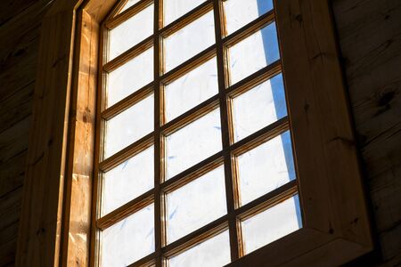 Light Stream through Window. Shafts of light stream through stained glass window inside a churchの写真素材