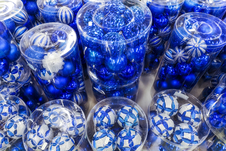 Sale of Christmas toys in the supermarket. Balls of blue colors for the Christmas tree on the supermarket shelves. Christmas toys for sale in the store. Variety of  blue glass ballsの写真素材