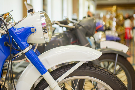 Row of many motorcycle for sale. Motorcycles standing in the row at a store, closeup. Motobikes in a rowの写真素材