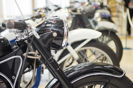 Row of many motorcycle for sale. Motorcycles standing in the row at a store, closeup. Motobikes in a rowの写真素材