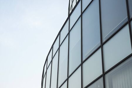 Modern building glass wall. Urban abstract background, detail of modern glass facade, office business buildingの写真素材