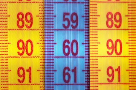 Three measuring tapes showing 90-60-90 as ideal parameters for women. The concept of an ideal figure of a womanの写真素材