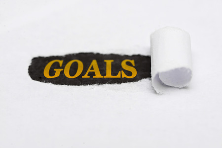 Paper tear with the word Goals. Goals written under tear folded paperの写真素材
