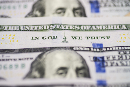 A lot of 100 US dollar bills banknotes. In god we trust. Bill hundred US dollars closeup phrase in god we trustの写真素材