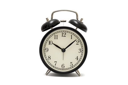Classic black table clock isolated on a white background. Black retro alarm clock isolated on white backgroundの写真素材