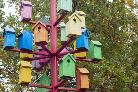 Lots of colorful nesting boxes. Many bright colored birdhousesの写真素材