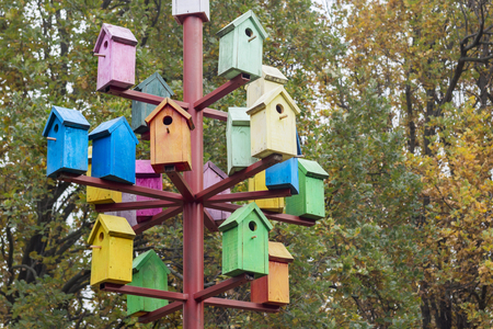 Lots of colorful nesting boxes. Many bright colored birdhousesの写真素材