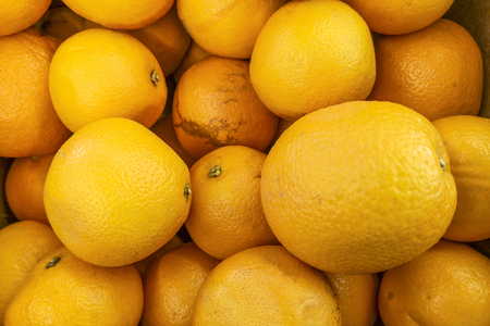 Bunch of fresh oranges on market. Healthy fruits, orange fruits background many orange fruits - orange fruit background in a supermarket super storeの写真素材