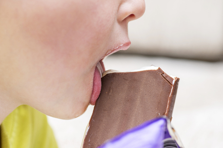Happy little kid licking ice creamの写真素材