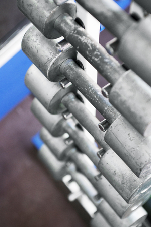 Rows of dumbbells in the gym. Dumbbell set. Many metal dumbbells on rack in sport fitness center. Top viewの写真素材