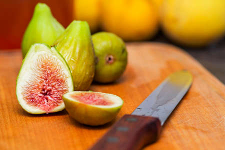 Ripe fresh figs on a wooden board with a knife. Ripe tasty figs.の写真素材
