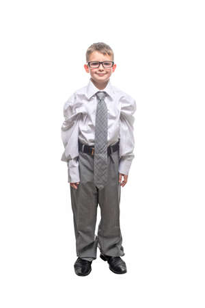 Small child dressed in a business suit and glasses as a businessman. Child in his fathers suit isolated on white background.の写真素材